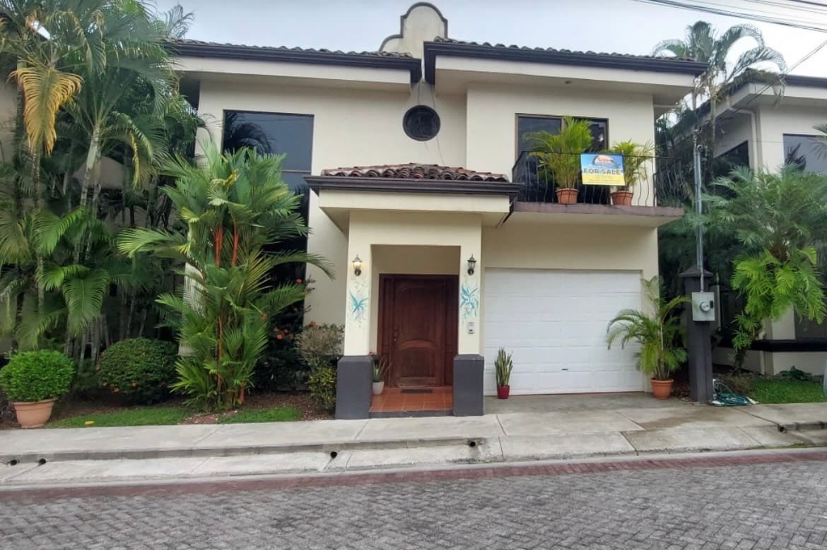 La Flor modern tropical beachfront home with lush palm landscaping in Jaco Beach