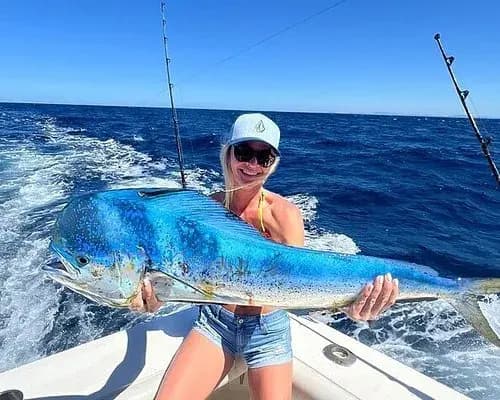 Couple celebrating a mahi-mahi catch on a private offshore fishing charter